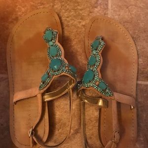 Nude colored sandals with light blue jewels.